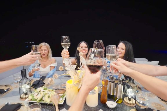 Yacht Charter Guests enjoying good wine onboard