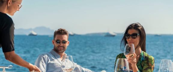 Guests enjoying good wine on luxury yacht